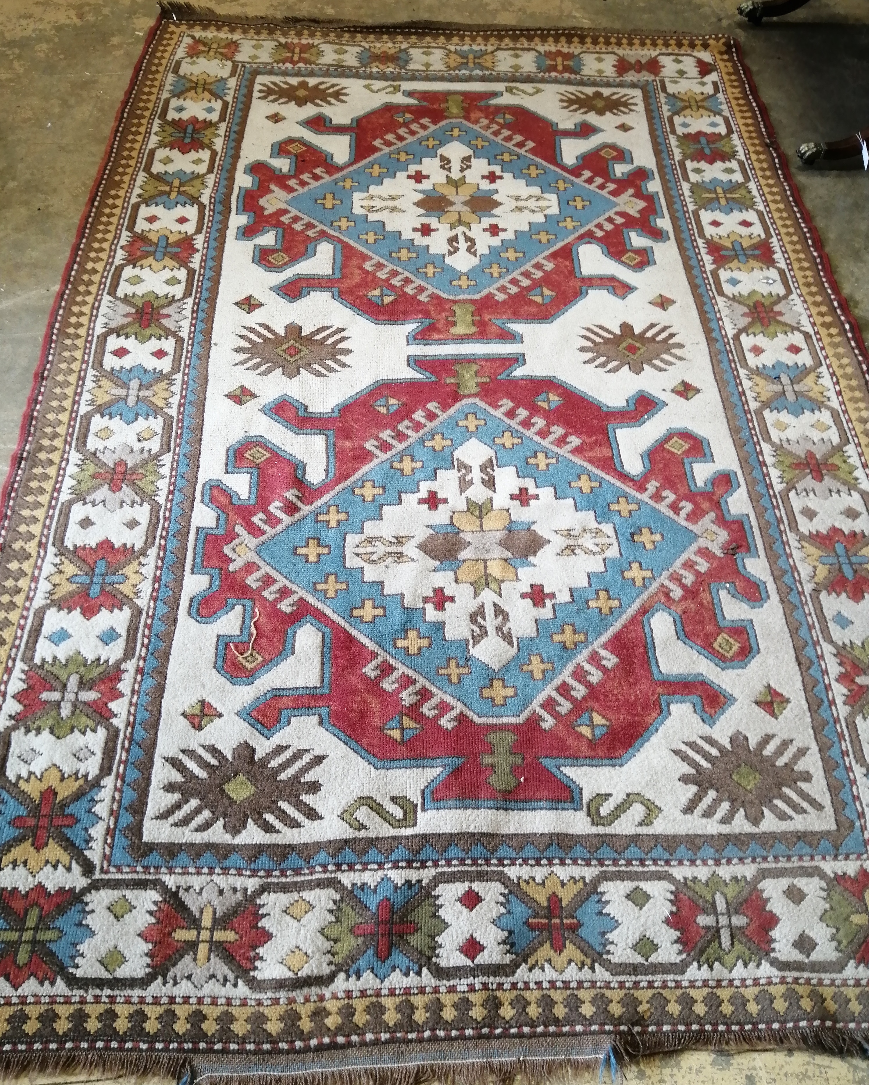 A Caucasian design ivory ground carpet, 270 x 170cm